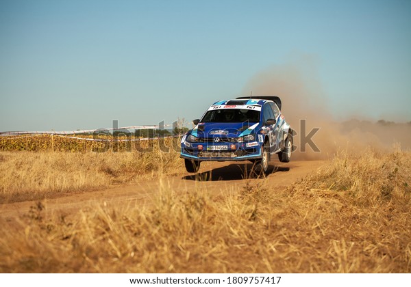 Volkswagen Polo rally car jumping in motion\
with clouds of dust during the Ukrainian Championship in mini-rally\
\