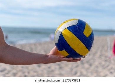 
volleyball ball in the hands of a man