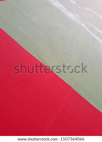 Volleyball court floor paint red and green, intentionally photographed geometric figure, close-up