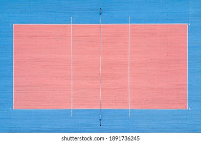 Volleyball Court Top View. Pink And Blue Wooden Floor In The Gym.