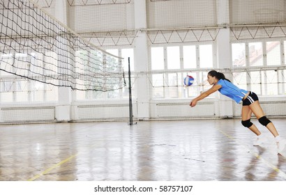 Volleyball Game Sport With Group Of Young Beautiful  Girls Indoor In Sport Arena