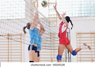 Volleyball Game Sport With Group Of Young Beautiful  Girls Indoor In Sport Arena