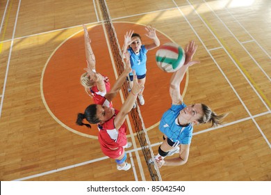 Volleyball Game Sport With Group Of Young Beautiful  Girls Indoor In Sport Arena