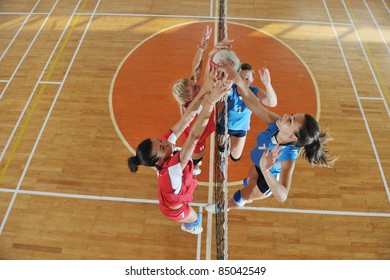 Volleyball Game Sport With Group Of Young Beautiful  Girls Indoor In Sport Arena