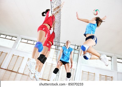 Volleyball Game Sport With Group Of Young Beautiful  Girls Indoor In Sport Arena