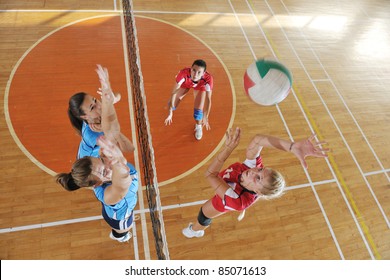 Volleyball Game Sport With Group Of Young Beautiful  Girls Indoor In Sport Arena