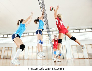 Volleyball Game Sport With Group Of Young Beautiful  Girls Indoor In Sport Arena