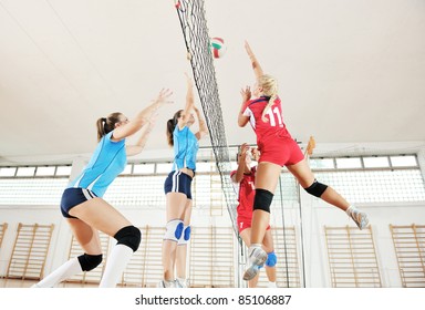 Volleyball Game Sport With Group Of Young Beautiful  Girls Indoor In Sport Arena