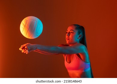 Volleyball girl hold and kick ball on neon background. Horizontal sport theme poster, greeting cards, headers, website and app - Powered by Shutterstock