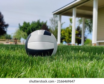 Volleyball In Grass By House