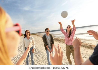 volleyball, leisure games and people concept - happy friends playing with ball on beach in summer - Powered by Shutterstock