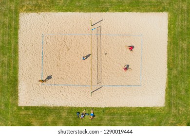 Volleyball Match On The Beach Volleyball Court From Above. Aerial View From Drone