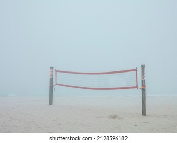 Volleyball Net On Sandy Coastal Beach In Thick Fog On A Winter Morning In Southwest Florida