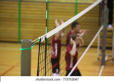 Volleyball Net In The Sport Hall With Players On Background