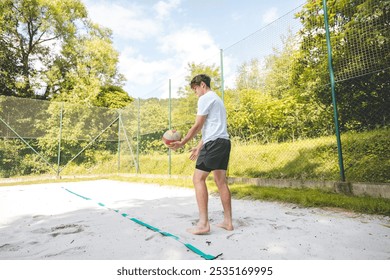 Volleyball player practicing a bump pass on a sand court, focusing on technique and control. Captured in an outdoor setting, showcasing beach volleyball skills and training. - Powered by Shutterstock