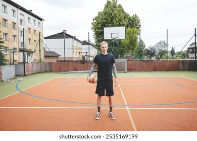 Volleyball player standing on a hard court, holding a ball with focus and determination before the game. The image captures a calm moment of preparation in an outdoor volleyball setting. - Powered by Shutterstock