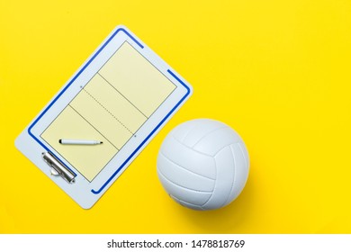 Volleyball and tactical board with marker on yellow background. Top view - Powered by Shutterstock