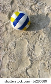 Volleyball yellow and blue in the sand