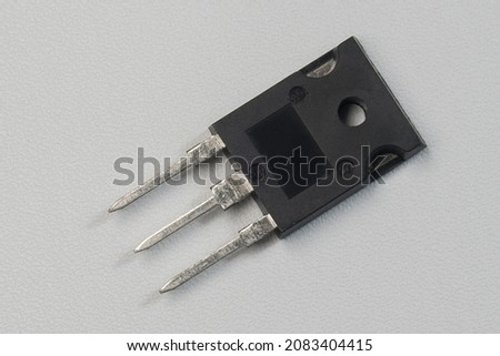 Voltage regulator transistor for power supply. Black transistor on white background isolated.