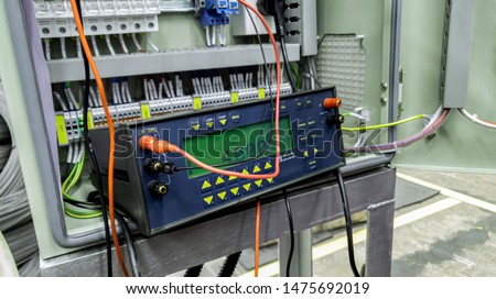 Voltage source calibrator device with control panel in factory site, Current and Voltage source instrument checking, Voltage measuring instrument hang on main braker substation