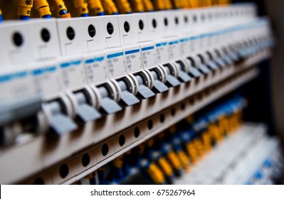 Voltage switchboard with circuit breakers. Electrical background - Shutterstock ID 675267964