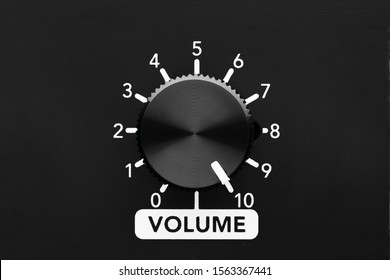 Volume Control Knob Of A Black Amplifier On Maximum Loudness. Close Up View With Copy Space. 