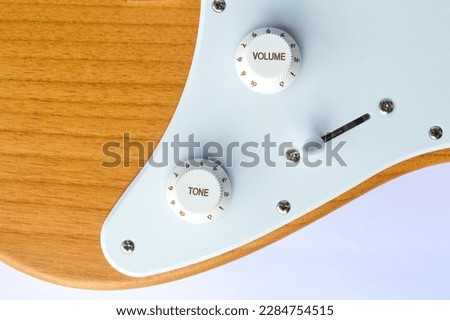 volume and tone control buttons, switch to move the pickup on the electric guitar
