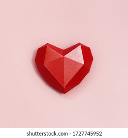 Volumetric paper heart red colored. Greeting card or invitation for wedding cards or Valentines Day. Pastel colors.