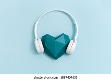 Volumetric paper heart in white headphones.  Concept for music festivals, radio stations, music lovers.  Live with music. Minimal style.  