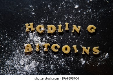 Voluntary Mistake In A Popular Saying In The Crypto Currency Community That Means To Hold Your Bitcoins While It Goes Down Sentence Made Of Uncooked Cookies On A Black Background With Flour