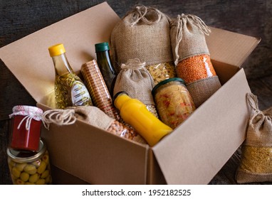 Volunteer with box of food for poor. Donation concept. Many foods in the package.  - Shutterstock ID 1952182525
