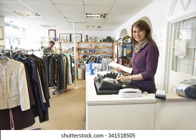 Volunteer In Charity Shop With Customer