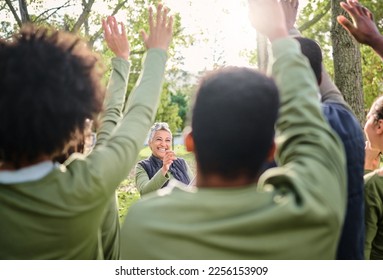 Volunteer, cleaning and group with vote for a woman in a park for the community environment. Teamwork, happy and people with questions for a senior leader during a nature cleanup for sustainability - Powered by Shutterstock