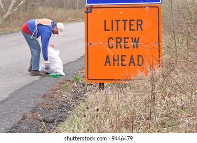 Volunteer Collecting Litter Along Country Road