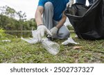 Volunteer Couple Collecting Trash in Nature, Environmental Conservation, Community Cleanup Effort, Eco-Friendly Activity, Outdoor Volunteering