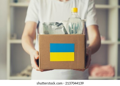 volunteer cyrrying box in woman hands with Humanitarian aid for Ukrainian refugees - Shutterstock ID 2137044139