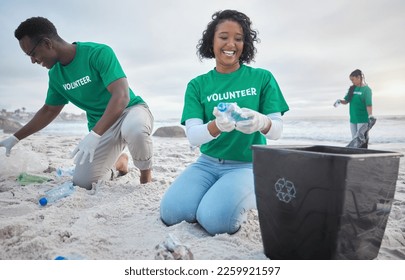 Volunteer group, beach clean and recycling plastic bottle for community service, pollution and earth day. Black woman and man ngo team cleaning sand for climate change, nature and helping environment