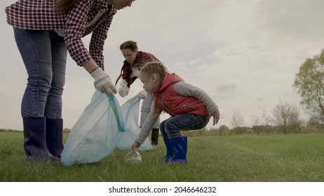 Volunteer Happy Family Collects Plastic Trash In Bags, Teamwork, Little Girl Helps Adults In The Fight For Environmental Protection, Eco, Kid With Mom Clears Land From Landfill, Charity Work