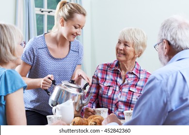 Volunteer Helping At Social Club For Seniors