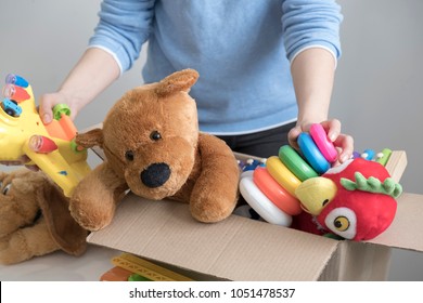 Volunteer Holding Donation Box With Old Toys.