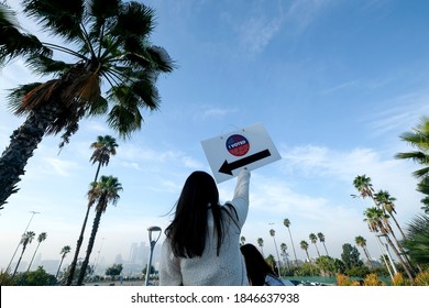 A Volunteer Holds A Direction Sign Outside A Vote Center In Dodgers Stadium During The Election Day In Los Angeles, Tuesday, Nov. 3, 2020.