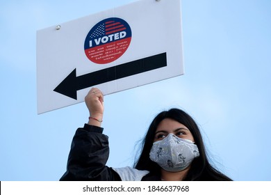 A Volunteer Holds A Direction Sign Outside A Vote Center In Dodgers Stadium During The Election Day In Los Angeles, Tuesday, Nov. 3, 2020.