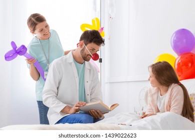 Volunteer in the hospital making sick girl happy 