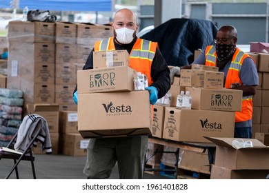 A Volunteer Loads Food Into The Trunk Of Vehicles During A ''Let's Feed L.A. County'' Drive Thru Food Distribution By The Los Angeles Regional Food Bank, April 23, 2021, In Rosemead, California.