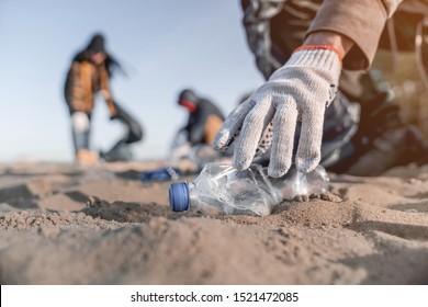 Volunteer man collecting trash on the beach. Ecology concept - Shutterstock ID 1521472085