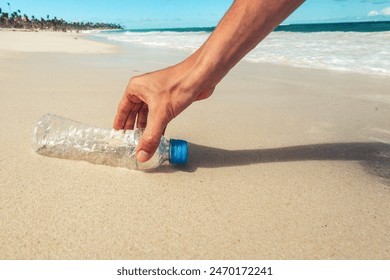 Volunteer man collecting trash on the beach. Ecology concept - Powered by Shutterstock