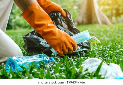 Volunteer man collecting trash.Garbage bottles picked up. Plastic and food waste concept. Clean planet Earth, collect garbage, save environment,save earth. - Powered by Shutterstock