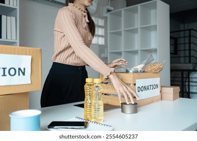 Volunteer Organizing Donations at Food Bank to Support Community and Aid in Hunger Relief Efforts - Powered by Shutterstock