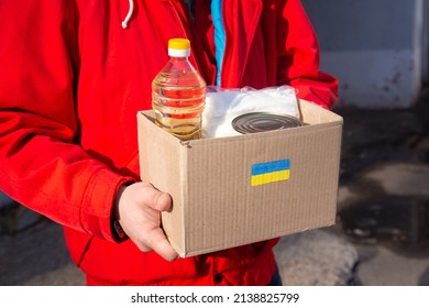 Volunteer preparing food box for ukrainian war refugees - Humanitarian help and aid concept - Shutterstock ID 2138825799