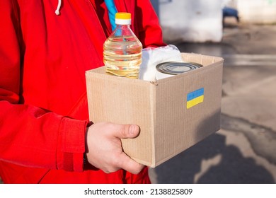 Volunteer preparing food box for ukrainian war refugees - Humanitarian help and aid concept - Shutterstock ID 2138825809
